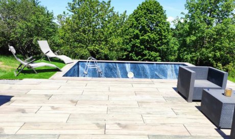 Terrasse dalle sur plot effet bois / Plage de piscine en gazon synthétique / Piscine carrelée en 60x120 poli brillant onyx bleu à Roanne